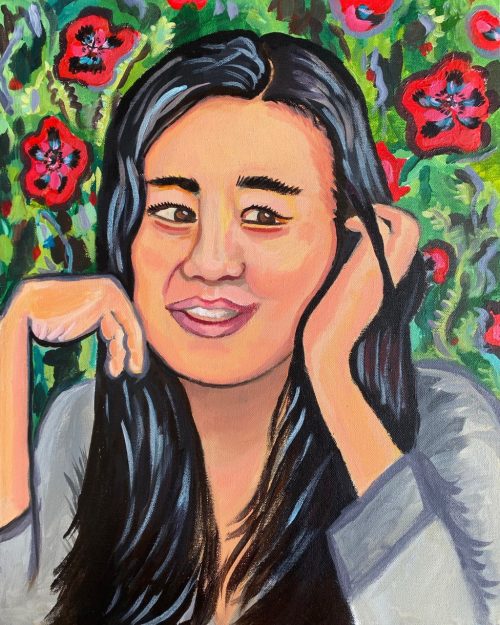 Portrait of Sandie Yi by Irina Zadov. Sandie cradles her head between her two hands, smiles, and looks off to the side. Her hair is long and black with shiny streaks, and her hands have two fingers. The background is a lush green scene with red flowers.